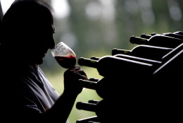 Walter Bressia tastes a wine in Mendoza, some 1000 kilometers (640 miles) west of Buenos Aires, Argentina, Friday, Feb. 24, 2006. Bressia uncorks his oaken barrels daily to check on the aging process of a high-end red wine to be sold abroad.Argentina's grapes are going global: the fifth-biggest wine producer in the world, clustered largely in leafy vineyards around the semi-arid western province of Mendoza, is cranking out wines to capture export markets. (AP Photo/Natacha Pisarenko)