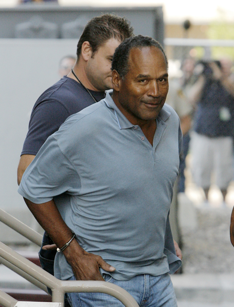 O.J. Simpson is transferred to the Clark County Detention Center in Las Vegas, in this Sunday, Sept. 16, 2007 file photo, after being arrested in connection with an alleged armed robbery in Las Vegas. Simpson wanted armed men with him when he confronted two sports memorabilia dealers, according to a co-defendant who pleaded guilty and has agreed to testify for the prosecution in the armed robbery case. (AP Photo/Jae C. Hong)