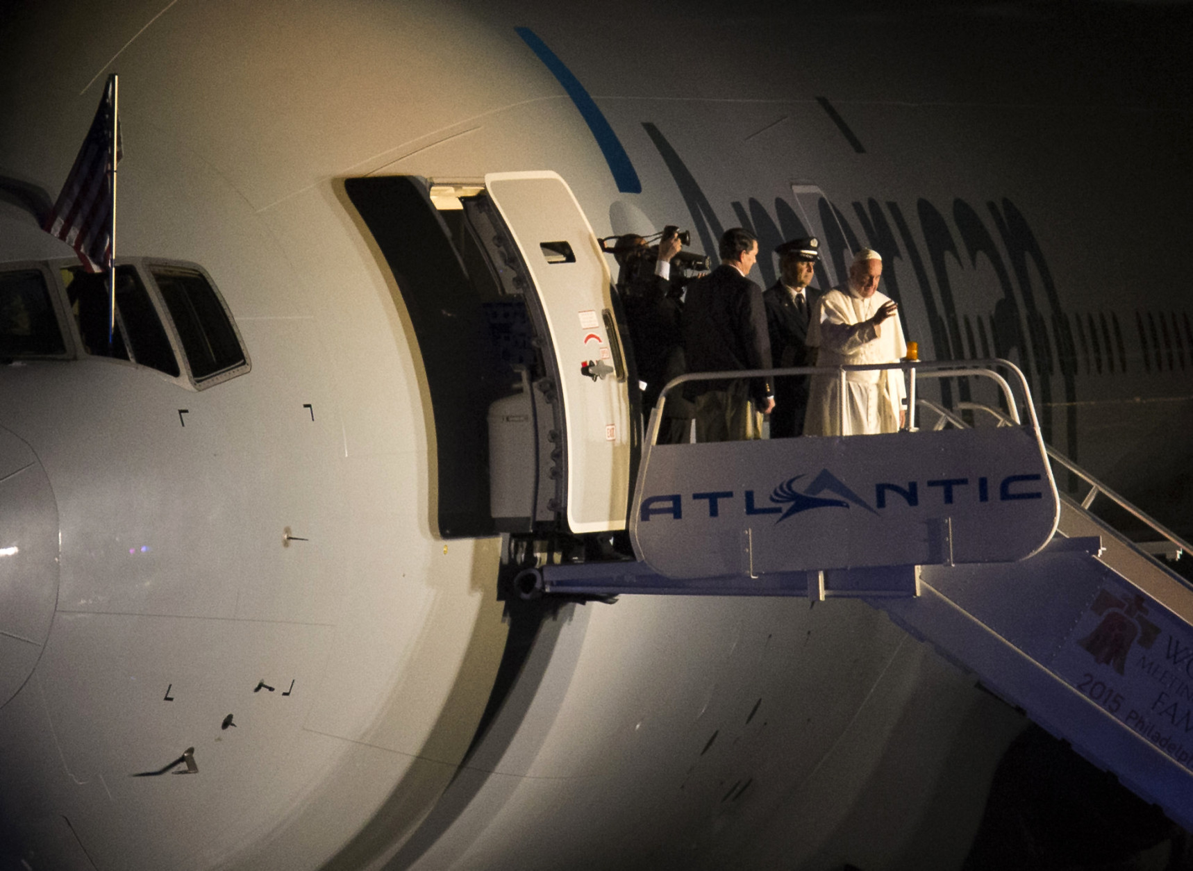 Pope Francis waves to the crowd at Philadelphia International Airport in Philadelphia as he departs for Rome on Sunday, Sept. 27, 2015. Pope Francis wrapped up his 10-day trip to Cuba and the United States on Sunday. (AP Photo/Laurence Kesterson, pool)