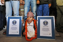 Nepal's Chandra Bahadur Dangi, 72, poses with his certificates after being declared the world's shortest living man and shortest man ever by the Guinness Book of Records, at a ceremony in Katmandu, Nepal, Sunday, Feb. 26, 2012. The 72-year-old man was measured at just 21.5 inches (54.6 centimeters) tall has been declared the shortest person to be recorded by the Guinness World Records snatching the title from Junrey Balawing of the Philippines, who is 23.5 inches (60 centimeters) tall. (AP Photo/Niranjan Shrestha)