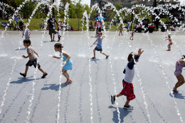 Excited children run though water as the fountains are turned on at Georgetown Waterfront Park in Washington, on Wednesday, June 20, 2012. Temperatures across the Northeast are expected to approach triple digits. (AP Photo/Jacquelyn Martin)