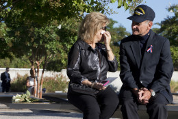 Betsy Wolk, with her husband Herb Wolk, of Columbia, Md., wipes her eyes as they visit the bench dedicated to their son-in-law, Navy Lt. Darin Pontell, Friday, Sept. 11, 2015, at the Pentagon Memorial on the 14th anniversary of the September 11th attacks. (AP Photo/Jacquelyn Martin)