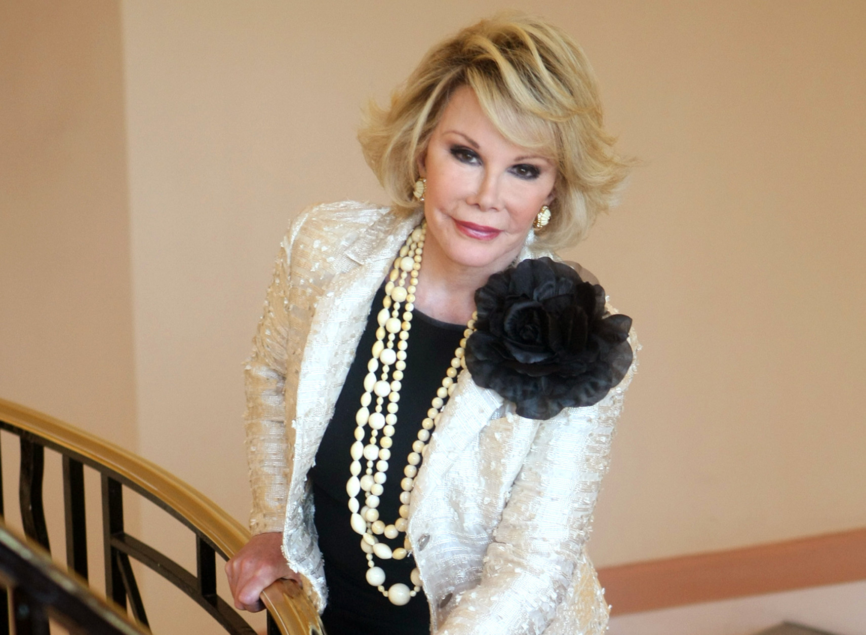 FILE - This Oct. 5, 2009, file photo shows Joan Rivers posing as she presents "Comedy Roast with Joan Rivers " during the 25th MIPCOM (International Film and Programme Market for TV, Video, Cable and Satellite) in Cannes, southeastern France. Rivers, the raucous, acid-tongued comedian who crashed the male-dominated realm of late-night talk shows and turned Hollywood red carpets into danger zones for badly dressed celebrities,  died Sept. 4, 2014.  She was 81. (AP Photo/Lionel Cironneau, File)