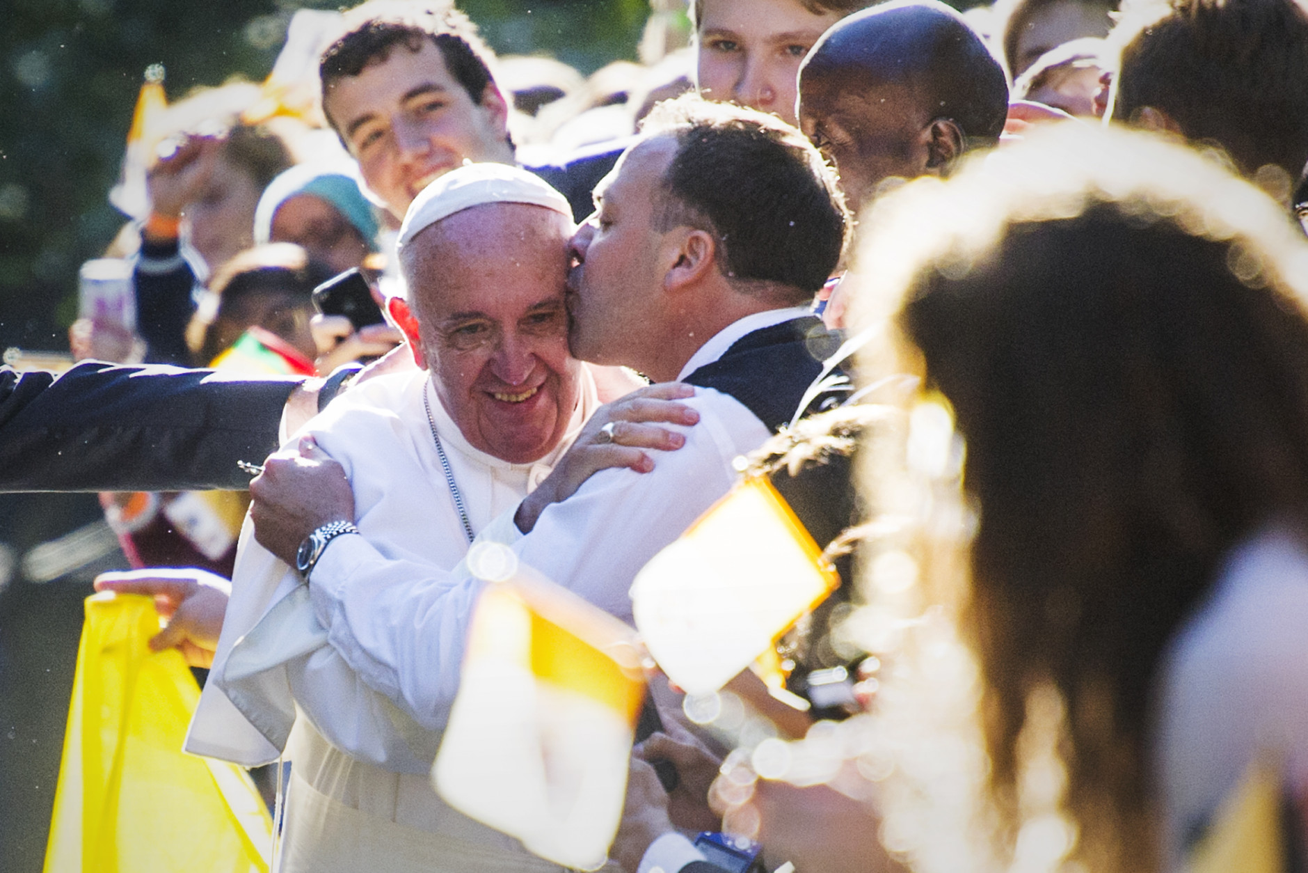 CROP OF DCCO110 * Pope Francis is kissed by a well-wisher as he departs the Apostolic Nunciature, the Vatican's diplomatic mission in the heart of Washington, Wednesday, Sept. 23, 2015. Pope Francis will visit the White House, becoming only the third pope to visit the White House.  (AP Photo/Cliff Owen)