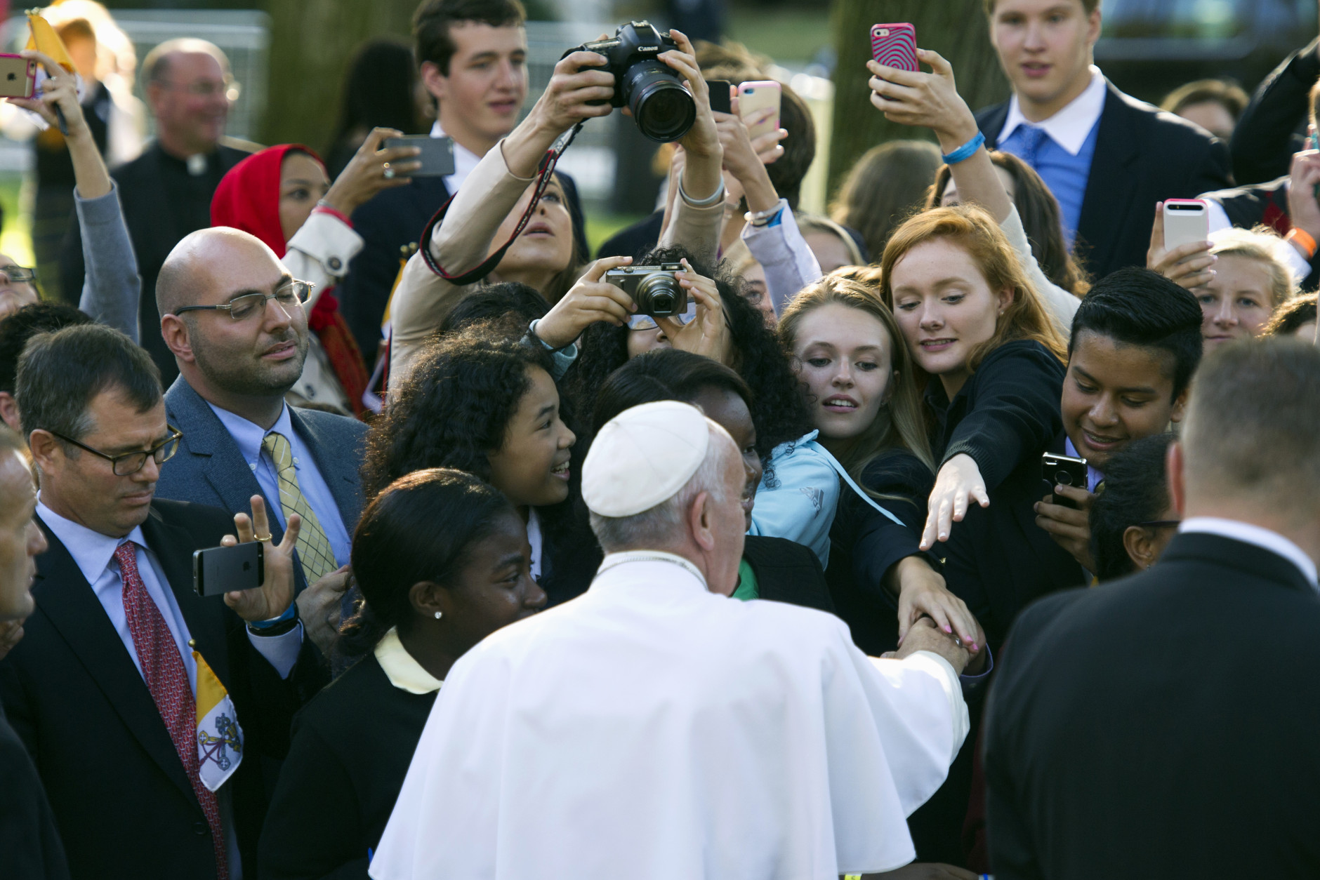 Pope Francis greets well-wishers as he departs the Apostolic Nunciature, the Vatican's diplomatic mission inWashington, Wednesday, Sept. 23, 2015. Pope Francis will visit the White House where President Barack Obama will host a state arrival ceremony.  (AP Photo/Cliff Owen)