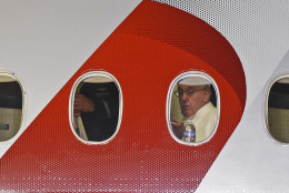 Pope Francis looks out the window a plane as he prepares to depart Philadelphia International Airport in Philadelphia, Sunday, Sept. 27, 2015, on his way back to Rome. Pope Francis wrapped up his 10-day trip to Cuba and the United States on Sunday. (AP Photo/Susan Walsh)