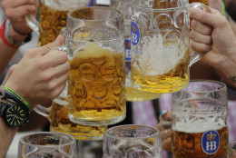 People celebrate the opening of the 181th Oktoberfest beer festival in Munich, southern Germany, Saturday, Sept. 20, 2014. The world's largest beer festival will be held from Sept. 20 to Oct. 5, 2014. (AP Photo/Matthias Schrader)