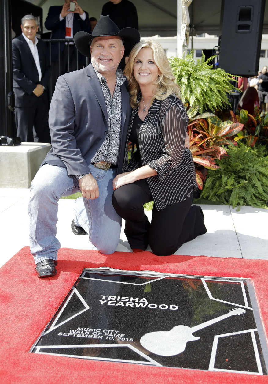 Country singer Trisha Yearwood is 51 on Sept. 19. Here, Yearwood poses with husband Garth Brooks after she was presented with her star on the Music City Walk of Fame Thursday, Sept. 10, 2015, in Nashville, Tenn. Both Yearwood and Brooks were given stars. (AP Photo/Mark Humphrey)