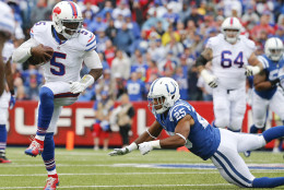 Buffalo Bills quarterback Tyrod Taylor (5) eludes Indianapolis Colts defensive back Jalil Brown (25) during the first half of an NFL football game on Sunday, Sept. 13, 2015, in Orchard Park, N.Y. (AP Photo/Bill Wippert)