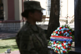 A NATO service member takes part in a memorial ceremony on the fourteenth anniversary of the 9-11 terrorist attacks on the United States at the headquarters of the International Security Assistance Force, in Kabul, Afghanistan, Friday, Sept. 11, 2015. (AP Photo/Rahmat Gul)
