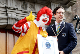 IMAGE DISTRIBUTED FOR MCDONALD'S - Jack Brockbank, Guinness World Records judge, is presented a certificate at the McDonald's and Guinness World Records event during Redhead Festival in Breda, The Netherlands on Sunday, Sept. 1, 2013. 1,672 redheads, accompanied by famous redhead Ronald McDonald, set the Guinness World Record for the largest gathering of redheads at the 2013 Redhead Days Festival. More than 5,000 redheads attended the global event from 80 countries. Throughout the weekend, Ronald McDonald served as the Redhead Days official ambassador by delivering smiles to many people.  McDonalds is making a $1 donation to Ronald McDonald House Charities (up to $10,000 USD) for every person who changes their Facebook or Twitter profile picture using www.mcdonalds.com/mcdsmiles, #mcdsmiles. (Patrick Post/AP Images for McDonald's)