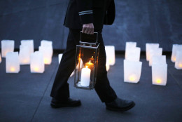 A United Airlines flight crew member participates in a candlelight memorial for the passengers and crew of United Flight 93, at the Flight 93 National Memorial in Shanksville, Pa, Thursday, Sept. 10, 2015. The new $26 million visitors complex is expected to draw a larger crowd than normal for the 14th anniversary observance at the Flight 93 National Memorial. (AP Photo/Gene J. Puskar)