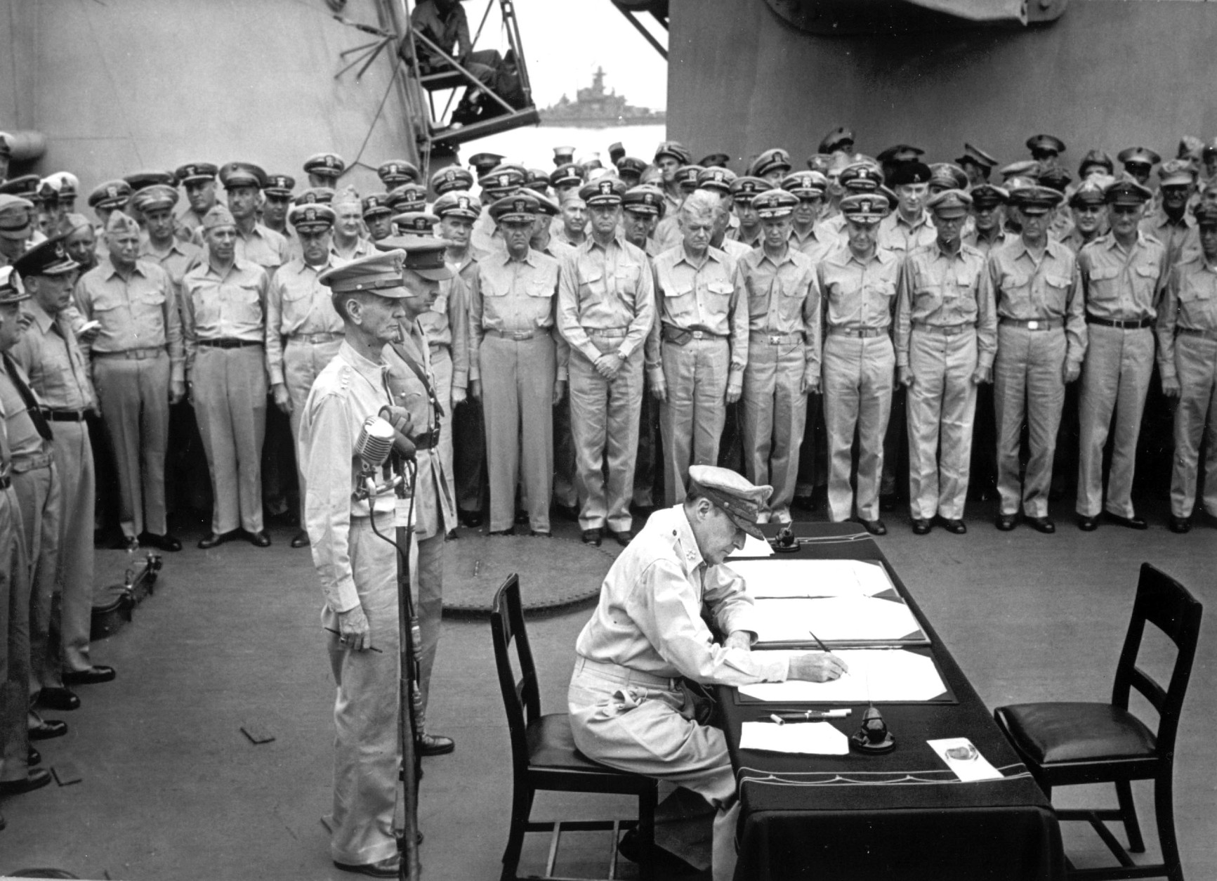 On September 2, 1945, Japan formally surrendered in ceremonies aboard the USS Missouri in Tokyo Bay, ending World War II. Here, Gen. Douglas MacArthur signs the Japanese surrender documents. (AP Photo)