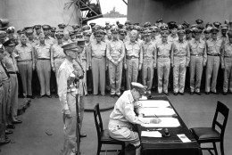 On September 2, 1945, Japan formally surrendered in ceremonies aboard the USS Missouri in Tokyo Bay, ending World War II. Here, Gen. Douglas MacArthur signs the Japanese surrender documents. (AP Photo)