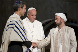 Pope Francis looks at Imam Khalid Latif, right, and Rabbi Elliot J. Cosgrove, left, shaking hands as he arrives for an interfaith service at the Sept. 11 memorial museum in New York, Friday Sept. 25, 2015. (AP Photo/Alessandra Tarantino)
