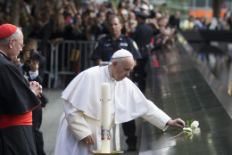 Pope Francis places a white rose at the South Pool of the 9/11 Memorial in downtown Manhattan, Friday, Sept. 25, 2015, in New York. (AP Photo/John Minchillo)