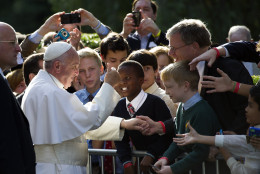 Pope Francis gives a thumbs-up while greeting school children before departing the Apostolic Nunciature, the Vatican's diplomatic mission in Washington, Thursday, Sept. 24, 2015, en route to the Capitol to address a joint meeting of Congress.  (AP Photo/Cliff Owen)