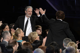 Jon Stewart gives Chuck O'Neil a high five at the 67th Primetime Emmy Awards on Sunday, Sept. 20, 2015, at the Microsoft Theater in Los Angeles. (Photo by Phil McCarten/Invision for the Television Academy/AP Images)