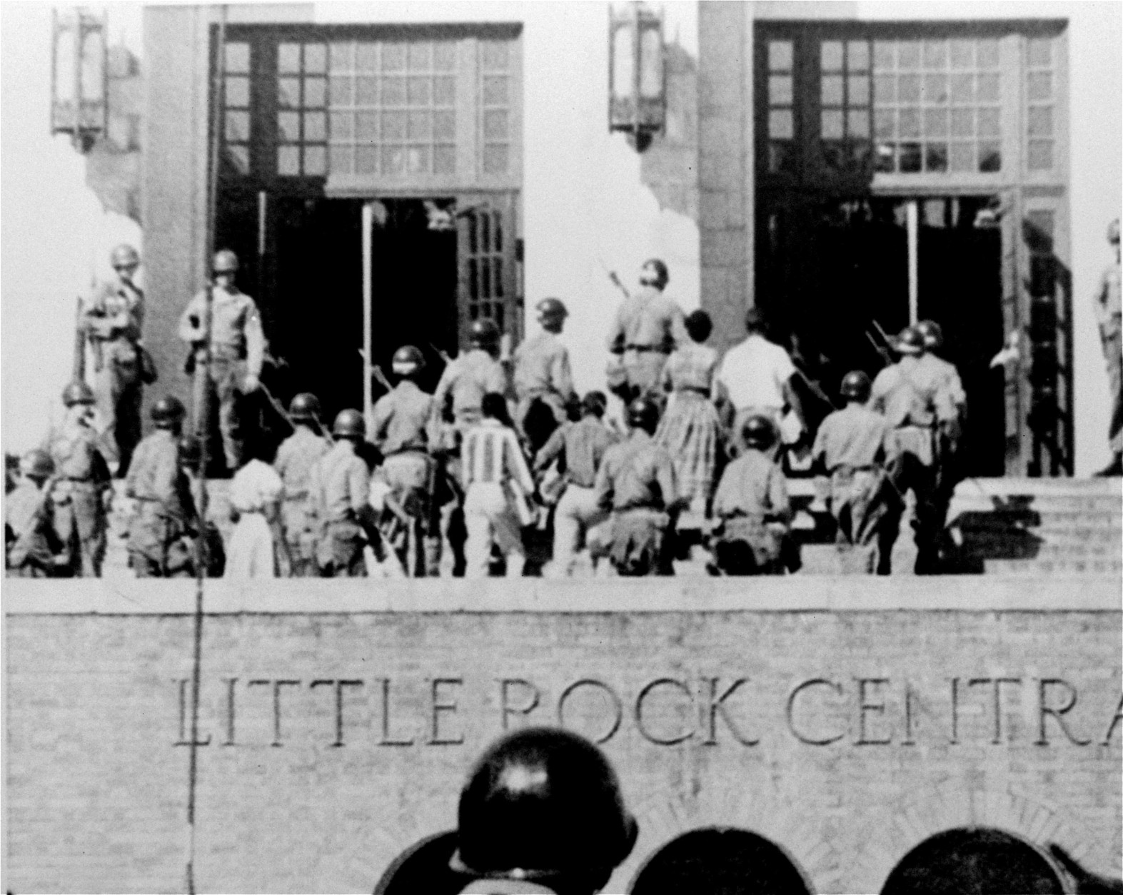 ** FILE ** In this Sept. 25, 1957, file photo, troops of the 101st Airborne Division escort  nine black students into Little Rock Central High School. The city is marking the 50th anniversary of Central High School's integration in September 2007 with a series of events culminating in a ceremony featuring former president Bill Clinton and the Little Rock Nine. (AP Photo, File)