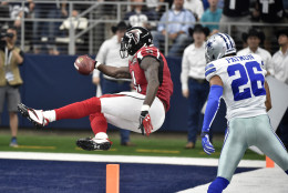 Atlanta Falcons wide receiver Julio Jones (11) sails into the end zone for a touchdown as Dallas Cowboys defensive back Tyler Patmon (26) watches in the second half of an NFL football game on Sunday, Sept. 27, 2015, in Arlington, Texas. (AP Photo/Michael Ainsworth)