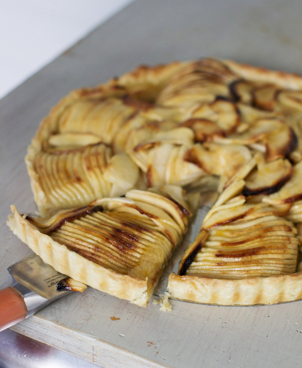 This Sept. 8, 2014 photo shows French apple tart in Concord, N.H. When slicing the apple stop each slice when youre still about 1/4 inch from the surface of the cutting board. According to chef Sara Moulton it is easier to slice an apple thinly when each slice remains attached at the bottom. (AP Photo/Matthew Mead)
