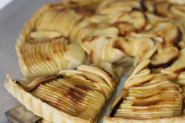 This Sept. 8, 2014 photo shows French apple tart in Concord, N.H. When slicing the apple stop each slice when youre still about 1/4 inch from the surface of the cutting board. According to chef Sara Moulton it is easier to slice an apple thinly when each slice remains attached at the bottom. (AP Photo/Matthew Mead)