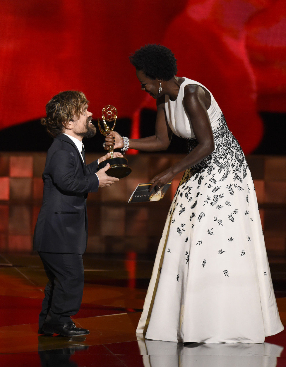 Viola Davis, right, presents Peter Dinklage with the award for outstanding supporting actor in a drama series for Game of Thrones at the 67th Primetime Emmy Awards on Sunday, Sept. 20, 2015, at the Microsoft Theater in Los Angeles. (Photo by Chris Pizzello/Invision/AP)