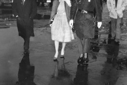 A U.S. military policeman escorts Priscilla Beaulieu, 16, after she broke through a barrier trying to bid her boyfriend Elvis Presley goodbye at Rhine-Main airbase in Frankfurt/Main, Germany on March 2, 1960. (AP Photo)