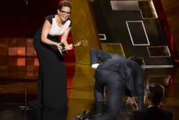 Jon Hamm crawls on stage to accept the award from Tina Fey for outstanding lead actor in a drama series for Mad Men at the 67th Primetime Emmy Awards on Sunday, Sept. 20, 2015, at the Microsoft Theater in Los Angeles. (Photo by Phil McCarten/Invision for the Television Academy/AP Images)