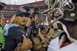 Tennessee Titans quarterback Marcus Mariota, left, shakes hands with Tampa Bay Buccaneers quarterback Jameis Winston after the Titans defeated the Buccaneers 42-14 during an NFL football game Sunday, Sept. 13, 2015, in Tampa, Fla. (AP Photo/Scott Audette)