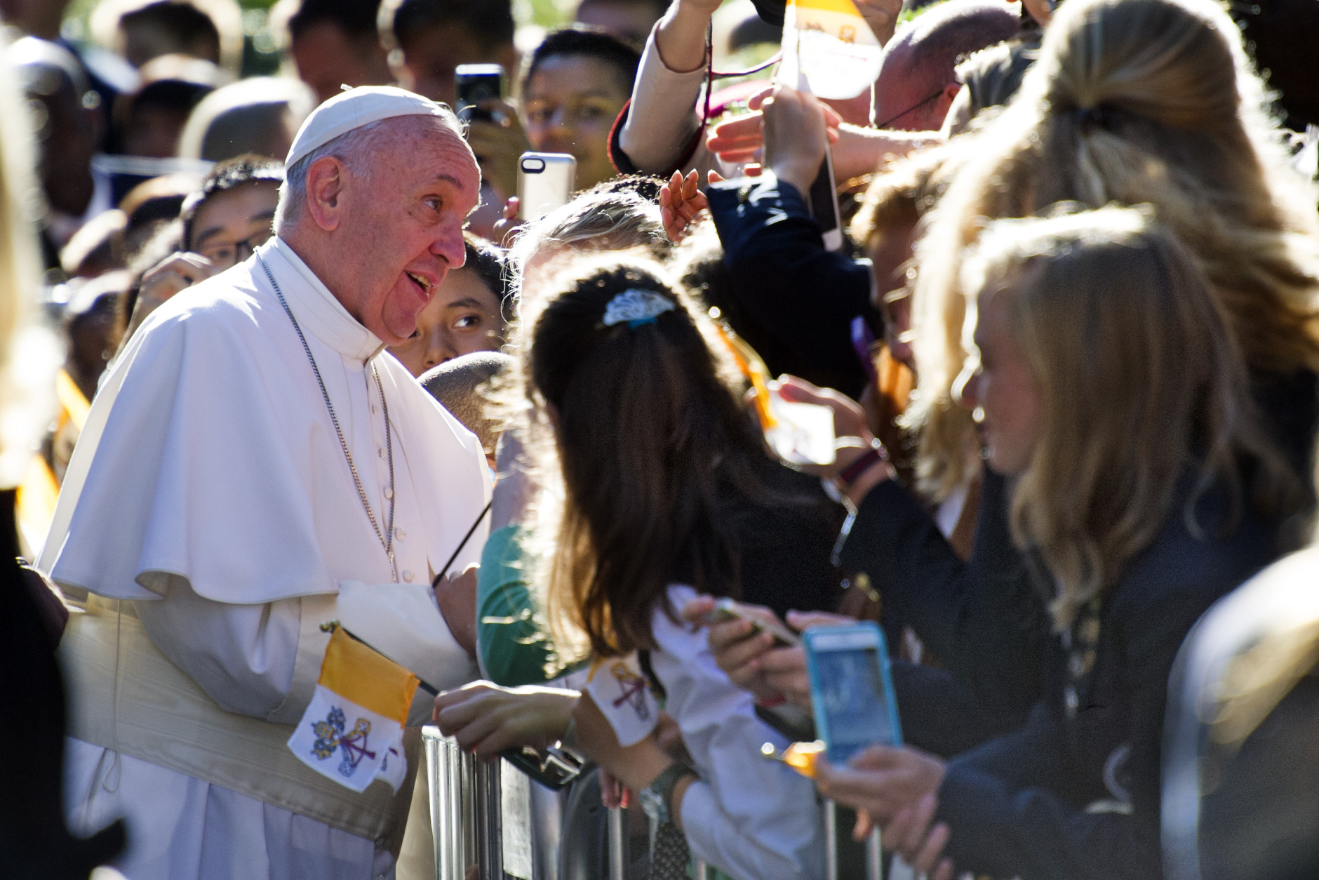 Pope Francis talks with school children as he departs the Apostolic Nunciature, the Vatican's diplomatic mission in the heart of Washington, Wednesday, Sept. 23, 2015. Pope Francis will visit the White House, becoming only the third pope to visit the White House.  (AP Photo/Cliff Owen)