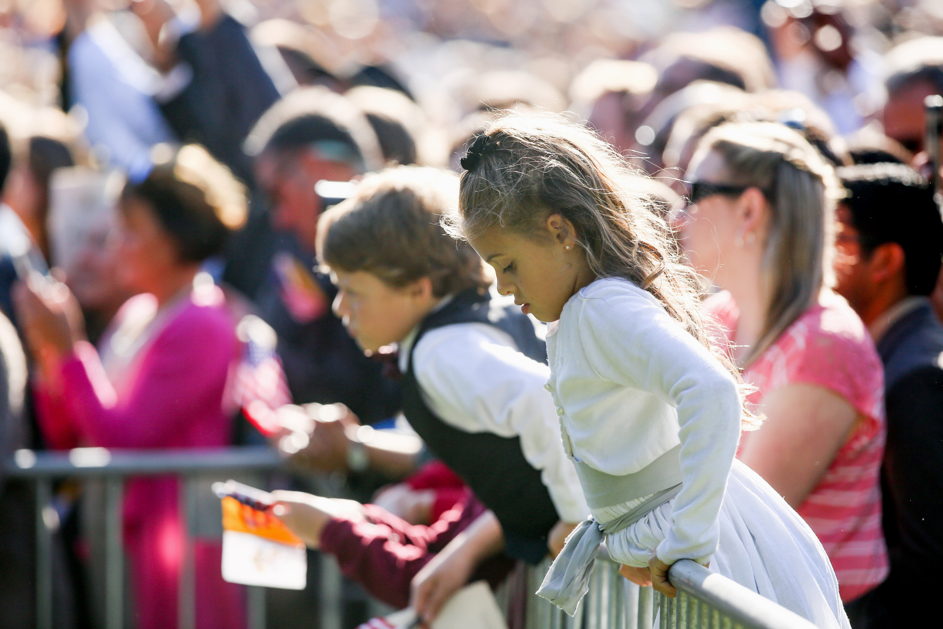 Young members of the audience stand on the South Lawn of the White House in Washington, Wednesday, Sept. 23, 2015, during a state arrival ceremony for the Pope Francis. (AP Photo/Andrew Harnik)