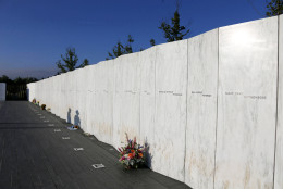 A National Park Ranger's shadow falls on the Wall of Names at sunrise before a Service of Remembrance at the Flight 93 National Memorial in Shanksville, Pa, Friday, Sept. 11, 2015, as the nation marks the 14th anniversary of the Sept. 11 attacks. (AP Photo/Gene J. Puskar)