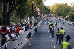 People and security line the parade route on 17th Street looking toward Constitution Avenue for Pope Francis, Wednesday, Sept. 23, 2015, in Washington. The parade will take place after President Barack Obama welcomes him at the White House. (AP Photo/Alex Brandon, Pool)