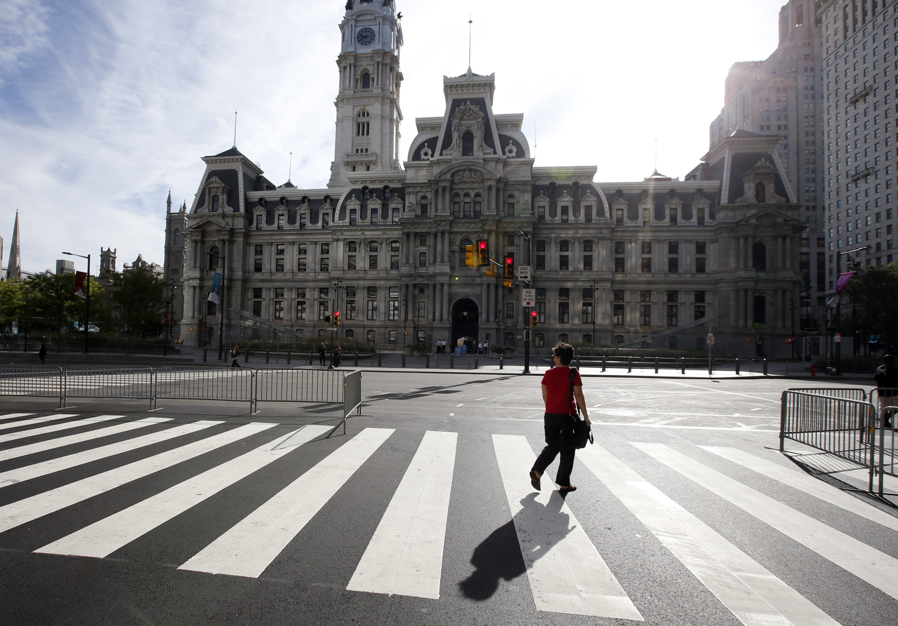 A woman walks around a quiet City Hall in Philadelphia on Friday, Sept. 25, 2015, before Pope Francis' upcoming visit. (AP Photo/Alex Brandon)