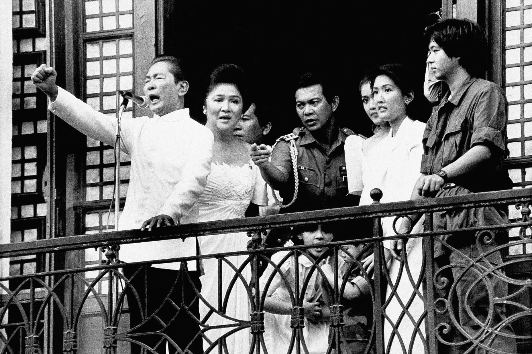 Ferdinand E. Marcos with his wife, Imelda at his side, gestures strongly from the balcony of Malacanang Palace on Tuesday, Feb. 25, 1986 in Manila, just after taking the oath of office as President of the Philippines. Just hours later, Marcos resigned and fled to the U.S. Air Force?s Clark Air Base, 50 miles northwest of Manila, as he prepared to accept an American offer to fly him out of the Philippines. (AP Photo/Alberto Marquez)