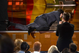 Jon Hamm crawls on stage to accept the award for outstanding lead actor in a drama series for Mad Men at the 67th Primetime Emmy Awards on Sunday, Sept. 20, 2015, at the Microsoft Theater in Los Angeles. (Photo by Phil McCarten/Invision for the Television Academy/AP Images)