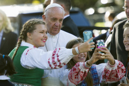 Children of parents who work at the Lithuanian Embassy take selfies with Pope Francis as he departs the Apostolic Nunciature, the Vatican's diplomatic mission in Washington, Wednesday, Sept. 23, 2015. Pope Francis will visit the White House where President Barack Obama will host a state arrival ceremony.  (AP Photo/Cliff Owen)