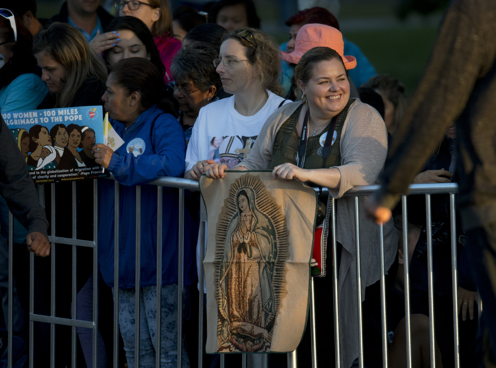 A woman holds an image of the Virgin Mary as she and others gather on the Pope Francis parade route along the Ellipse near the White House in Washington, Wednesday, Sept. 23, 2015. (AP Photo/Carolyn Kaster)