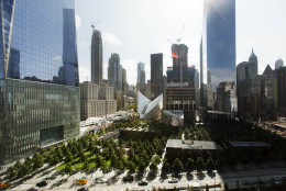 This Wednesday, Sept. 9, 2015 photo shows the National September 11 Memorial and Museum, center foreground, surrounded by One World Trade Center, left, the white v-shaped transportation hub, center, and 4 World Trade Center, the tall building at right, in New York. The building under construction at center right is 3 World Trade Center. Friday will mark the 14th anniversary of the Sept. 11 terrorist attacks on the United States. (AP Photo/Mark Lennihan)