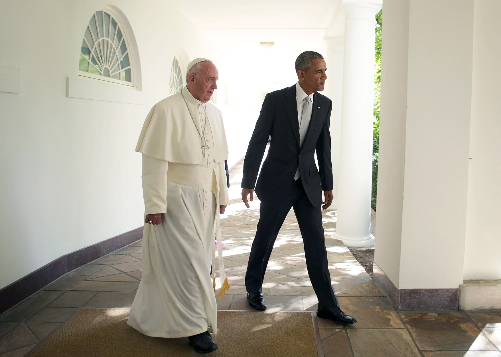 WASHINGTON, DC - SEPTEMBER 23:  U.S. President Barack Obama (R) and Pope Francis (L) walk through the colonnade prior to an Oval Office meeting at the White House on September 23, 2015 in Washington, DC. The Pope begins his first trip to the United States at the White House followed by a visit to St. Matthew's Cathedral, and will then hold a Mass on the grounds of the Basilica of the National Shrine of the Immaculate Conception.  (Photo by Alex Wong/Getty Images)