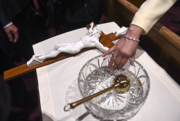 WASHINGTON, DC - SEPTEMBER, 23: A lady dips her finger in the holy water bowl that Pope Francis used to bless the crowd during Midday Prayer of the Divine with more than 300 U.S. Bishops at the Cathedral of St. Matthew the Apostle on September 23, 2015 in Washington, DC. The Pope is on a three-day visit of Washington, D.C. as part of a larger visit to the U.S. (Photo by Jonathan Newton-Pool/Getty Images)