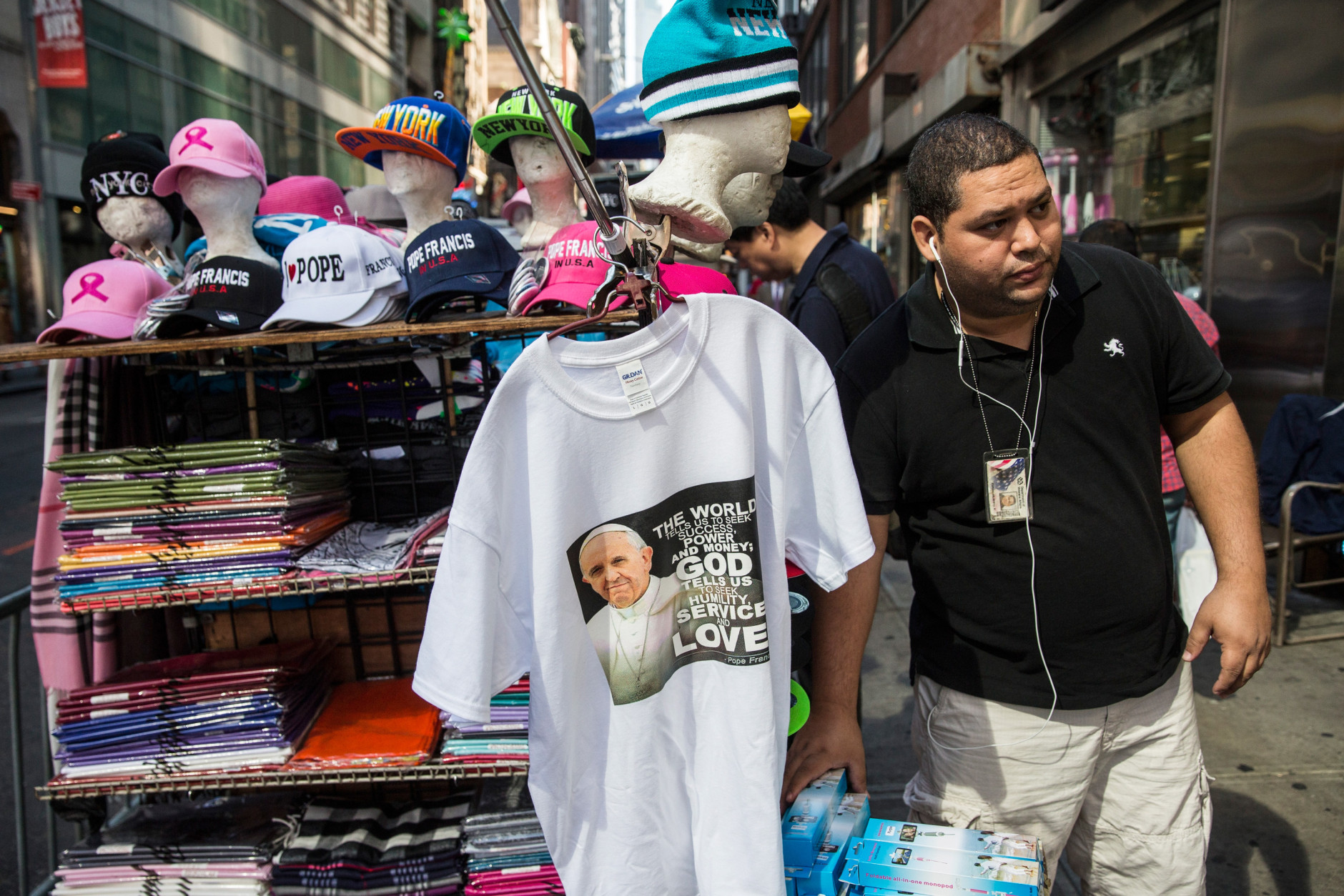 NEW YORK, NY - SEPTEMBER 24:  A man sells Pope Francis paraphernalia in Times Square on September 24, 2015 in New York City.  The Pope will speak tonight at St. Patrick's Cathedral; he is scheduled to land at John F. Kennedy Airport at 5P.M. this evening.  (Photo by Andrew Burton/Getty Images)