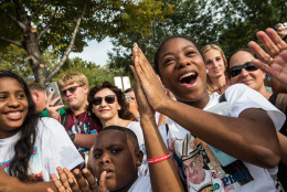 PHILADELPHIA, PA - SEPTEMBER 26: Ashley Cadet (C), cheers as she watches Pope Francis speak at the World Festival of Families on September 26, 2015 in Philadelphia, Pennsylvania. The Pope is concluding his U.S. tour by spending two days in Philadelphia; he previously visited Washington D.C. and New York City. (Photo by Andrew Burton/Getty Images)