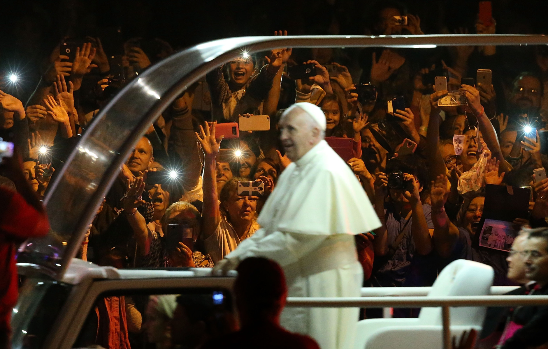 PHILADELPHIA, PA - SEPTEMBER 26:  Spectators react as Pope Francis rides by in the Popemobile as he arrives at the Festival of Families on September 26, 2015 in Philadelphia, Pennsylvania.  Pope Francis is wrapping up his trip to the United States with two days in Philadelphia where he will attend the Festival of Families and will meet with prisoners at the Curran-Fromhold Correctional Facility.  (Photo by Justin Sullivan/Getty Images)