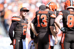 CLEVELAND, OH - SEPTEMBER 27:  Johnny Manziel #2 looks on while Josh McCown #13 of the Cleveland Browns huddles with teammates during the second quarter against the Oakland Raiders at FirstEnergy Stadium on September 27, 2015 in Cleveland, Ohio.  (Photo by Jason Miller/Getty Images)
