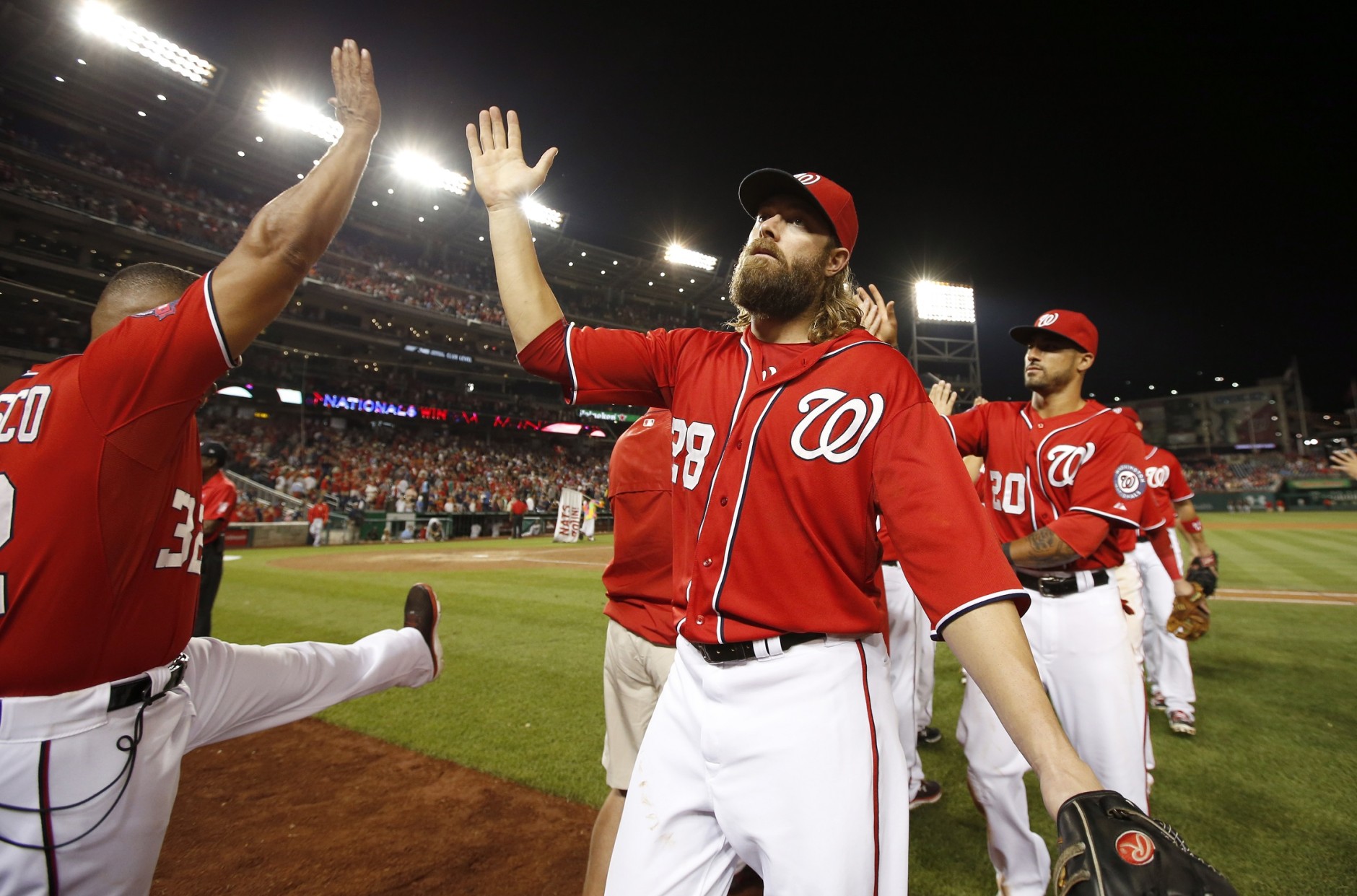 Washington Nationals left fielder Jayson Werth (28) and others celebrate after a baseball game against the Miami Marlins at Nationals Park, Saturday, Aug. 29, 2015, in Washington.  The Nationals won 5-1. (AP Photo/Alex Brandon)