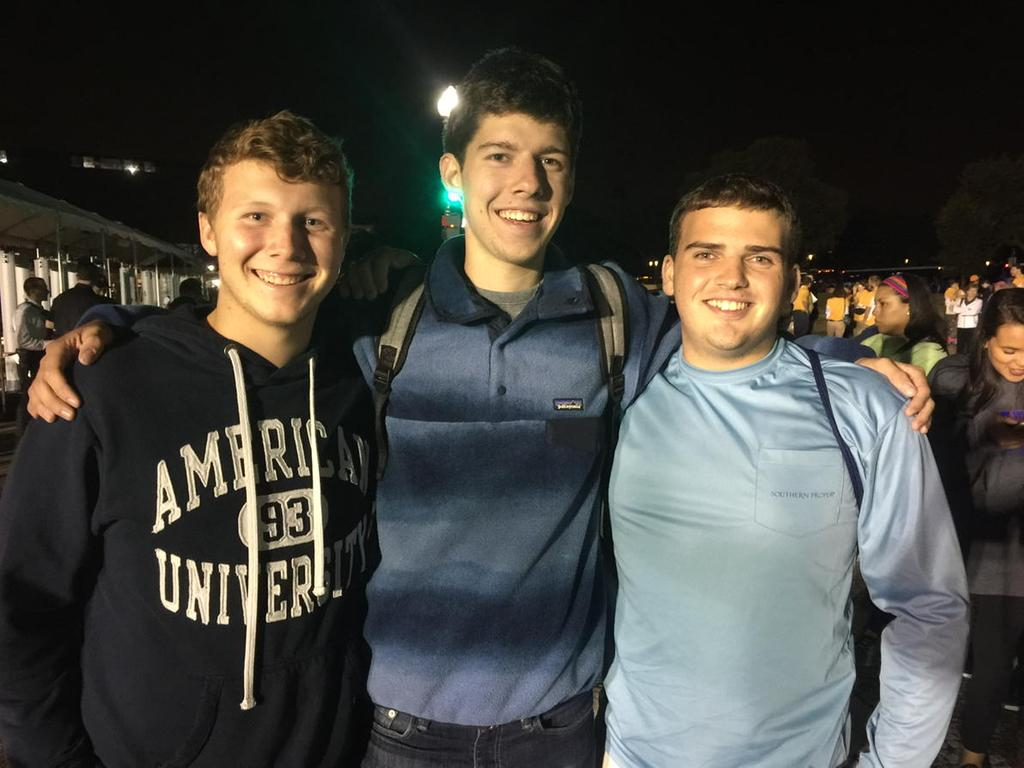 Ryan, Jackson and  Cameron say they're here for a once-in-a-lifetime event. They say they're "not even Catholic; we're two Jews and a gay!" (WTOP/Kristi King)