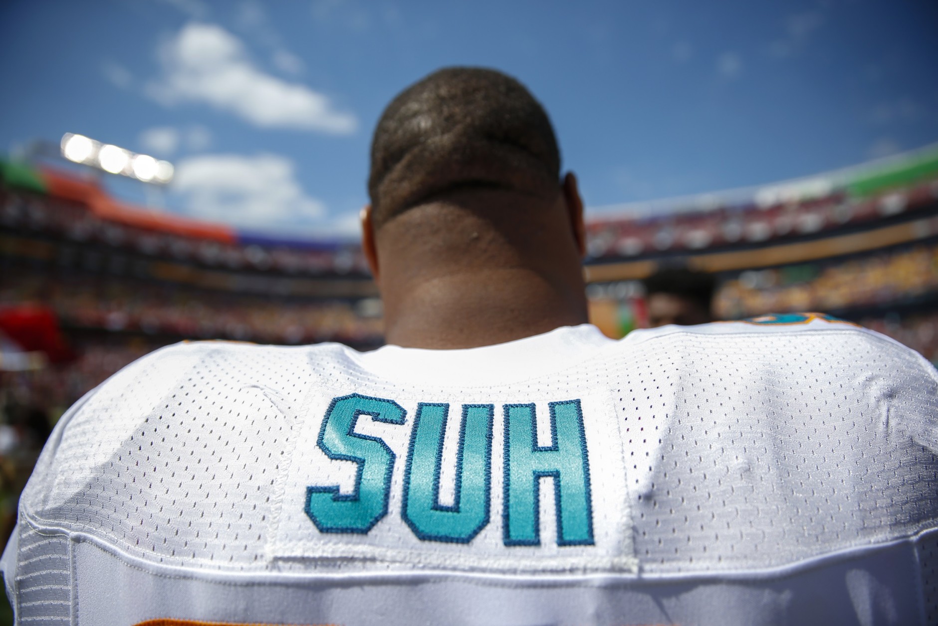 Miami Dolphins defensive tackle Ndamukong Suh looks at the field during pre-game warm ups before the start of an NFL football game against the Washington Redskins on Sunday, Sept. 13, 2015, in Landover, Md. (AP Photo/Evan Vucci)