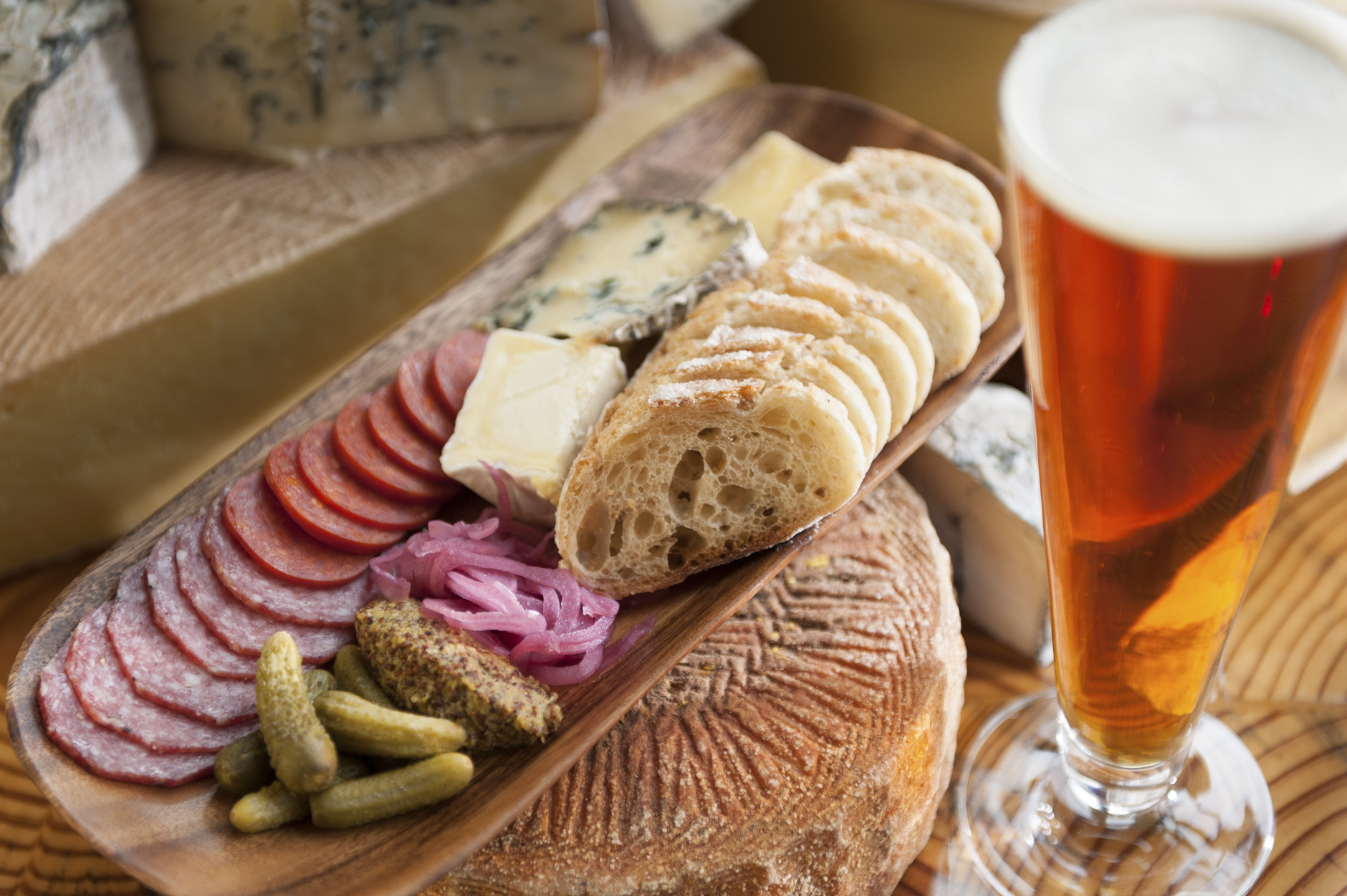 Bread, cheese and a tall glass of beer.